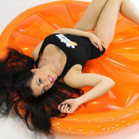 Kayla Kiss strips for you on her big orange inflatable