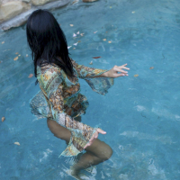 Stunning chick Sophia Bella wears a dress in the pool