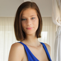 Lovely brunette model Mimi Lion posing in sexy blue dress