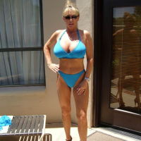 Gorgeous blond housewife with big tits in a blue bikini