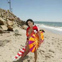 Busty MILF Veronica Rayne strips off bikini and posing on the beach