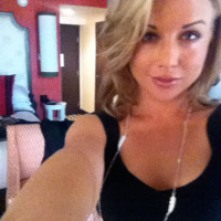 Kayden Kross playing with her phone camera at home