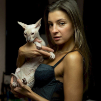 Melena Maria Rya showing her cat while posing in black lingerie