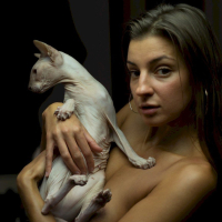 Melena Maria Rya showing her cat while posing in black lingerie
